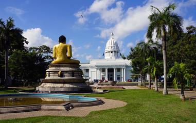 Colombo's white-domed Municipal Council building with a statue of the Buddha in the foreground