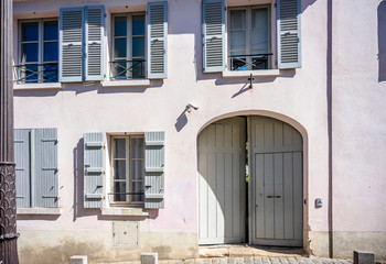 House with open wooden shutters and gates on an old street on Montmartre