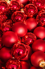 Red Christmas balls on a Xmas market. Close up. Traditional Happy New Year  Symbol.
