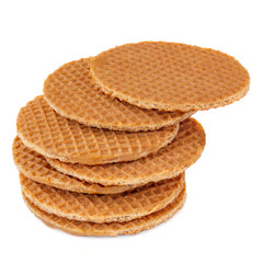 Pile of round dutch waffles with caramel and honey isolated on white background. Caramel...