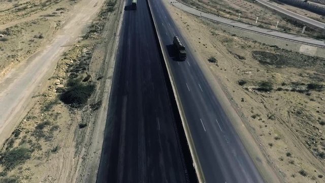 A top view of a motorway of the city, Heavy vehicles and others moving.