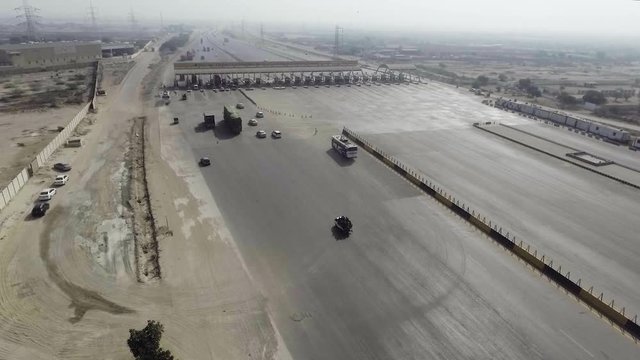 Top view of a motorway toll plaza of the city, Heavy vehicles and others entering and crossing.