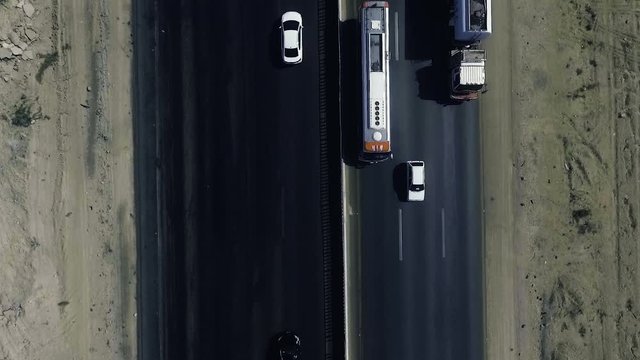 A slow mo aerial top view of traffic moving on a highway in northern areas.