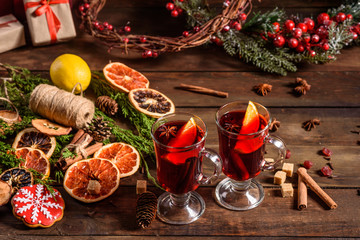 Christmas hot mulled wine with cinnamon cardamom and anise on wooden background