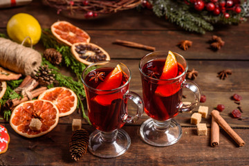 Fototapeta na wymiar Christmas hot mulled wine with cinnamon cardamom and anise on wooden background