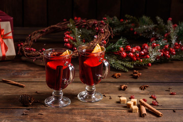 Naklejka na ściany i meble Christmas hot mulled wine with cinnamon cardamom and anise on wooden background