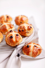Buns marked with a cross and containing dried fruit, traditionally eaten during Lent.