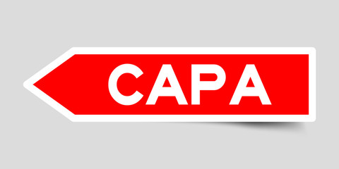 Label sticker in red color arrow shape as word CAPA (abbreviation of corrective action and preventive action) on white background