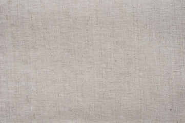 Fototapeta na wymiar Gray beige fabric texture background. Tablecloth. Natural linen fabric. factory