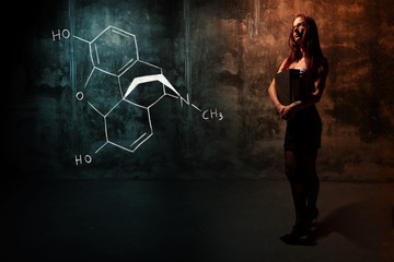 Fototapeta na wymiar Sexy girl or secretary or female student presenting handdrawn chemical formula of Morphine