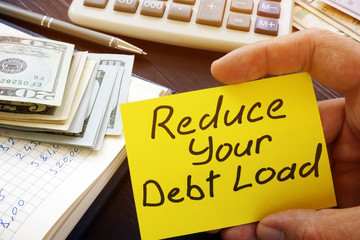 Man holds Reduce your debt load sign.