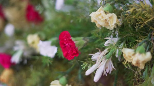 ndian festive decoration, red white and purple  flowers and green leaf arranged in alternate order,