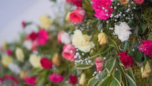 ndian festive decoration, red white and purple  flowers and green leaf arranged in alternate order,