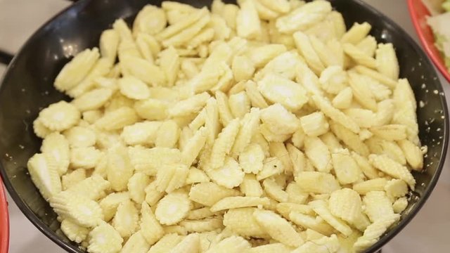Chopped baby corn in black pan healthy vegatable