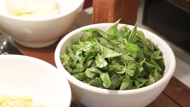 chopped palak in white bowl 