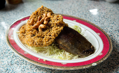 Crispy catfish spicy salad with green mango, Thai food, Crispy catfish salad with green mango and vegetable , served with tomato and lettuce