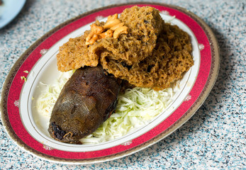 Crispy catfish spicy salad with green mango, Thai food, Crispy catfish salad with green mango and vegetable , served with tomato and lettuce