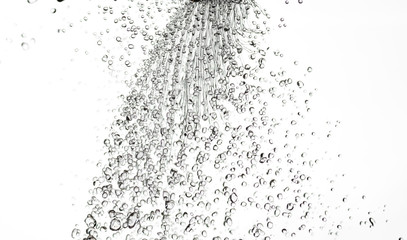 splashes, jets and drops of water hovering in the air on a white background