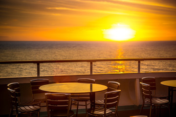 Cafe tables on balcony overlooking at sunset