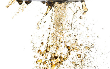 flying splashes, streams and drops of yellow and green lemonade hovered in the air on a white background