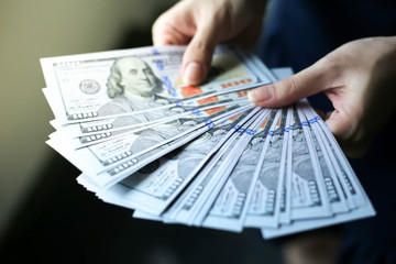 Selective focus of Hand receiving money from businesswoman,Concept of savings, salary, payment and...