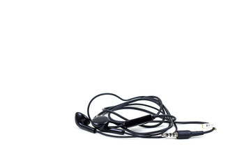 Black headphones with headset lie on white isolated background