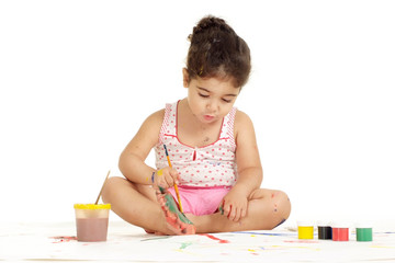 Portrait of nice young girl painting picture on a white background