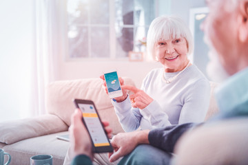 Elderly lady after checking weather forecast and planning picnic