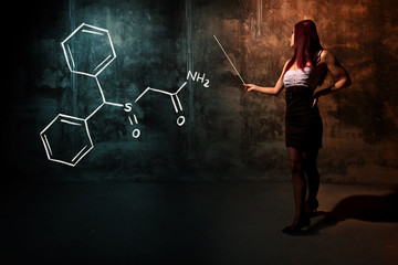 Sexy girl or secretary or female student presenting handdrawn chemical formula of Modafinil