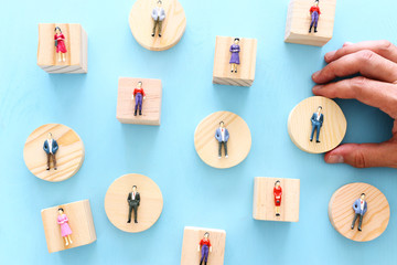 business concept image of people figures over wooden table, human resources and management concept