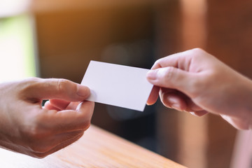 Two businessman holding and exchanging empty business card
