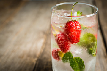 Raspberry mojito cocktail on the rustic background. Selective focus. Shallow depth of field.