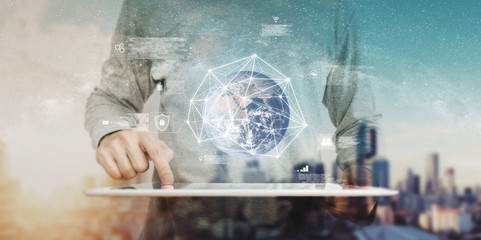 Smart technology and Global network, a man using digital tablet with global networking hologram. Element of this image are furnished by NASA