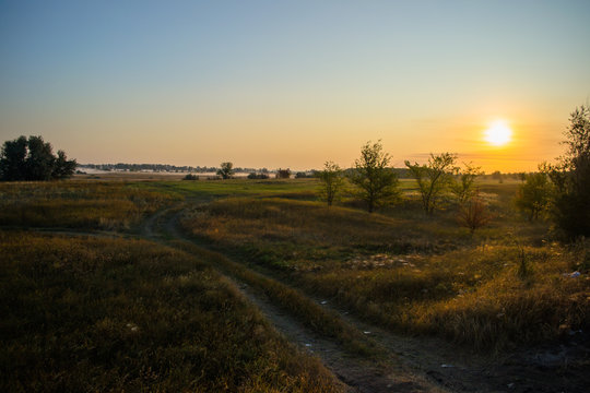 sunset over a field © Aleksandr