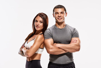 Portrait of two young fit sporty people with crossed hands - obrazy, fototapety, plakaty