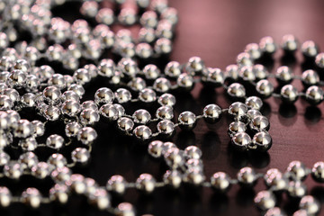 Silver Christmas decoration on a dark wooden background close up