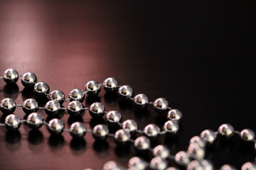 Silver Christmas decoration on a dark wooden background close up