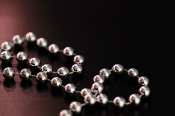 Silver Christmas decoration on a dark wooden background close up
