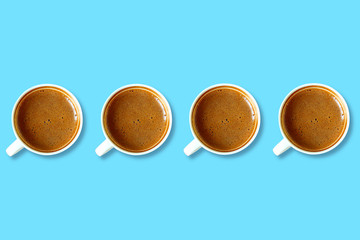 Cups of coffee on a blue background top view, minimal style.