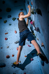 Teenage Boy Training On Climbing Wall