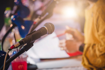 Business people talking on seminar panel with microphone