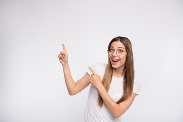 Sales manager lady indicating fingers up empty space on low prices wear specs and t-shirt isolated...