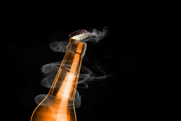 Cold wet bottle of chilled drink with drops. Opening of beer cap with the gas output.