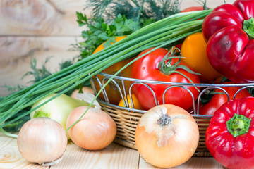 Natural homegrown raw organic food. Close up fresh harvested vegetables in wicker basket.