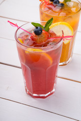 Glass of red juice with ice and strawberry