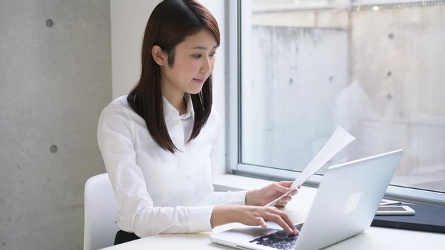 Young business woman finishing her work