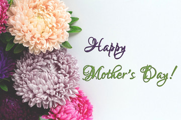 Happy mother's day text sign on white background. Mothers day card with beautiful aster flowers. Soft toning.