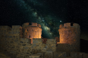 Starry night with the milky way in the sky at the historic fortress Cabo Tinoso near the Spanish port city of Cartagena. Masonry towers in the foreground.