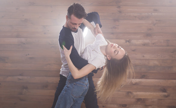 Young couple dancing latin dance bachata, merengue, salsa, kizomba. Two expressive pose over white background with copy space