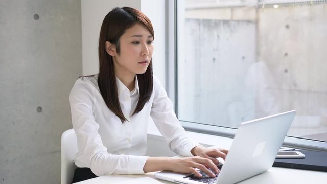 Young business woman finishing her work